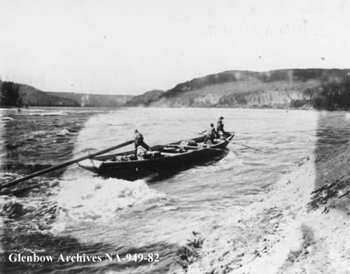 Boats being tracked up the Grand Rapids, Athabasca River, Alberta, 1899.